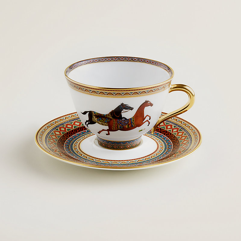 https://assets.hermes.com/is/image/hermesproduct/cheval-d-orient-tea-cup-and-saucer-n-1--009816P-worn-1-0-0-800-800_g.jpg